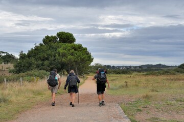 Fototapeta premium Senior hikers on a path at Paimpol in Brittany-France