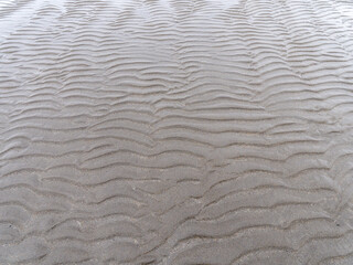 Relief on a sandy beach, full frame. Wavy pattern.