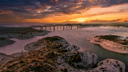 Aerial view of Amistad Reservoir with the Governor's Landing Bridge in Texas at sunset