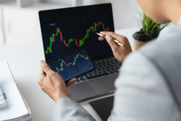 Businessman trading stocks with laptop talking about forex on laptop screens of stock market investment trading financial graph charts data analysis