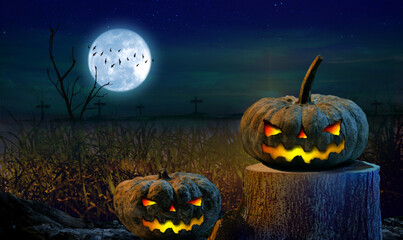 Halloween pumpkin on a tree stump Halloween background at forest night with moon.