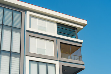 Image of the exterior of a residential building against a blue sky.