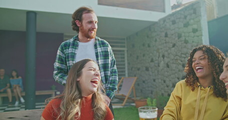 Family members and friends together at home backyard having barbecue in garden party. Happy people talking and laughing