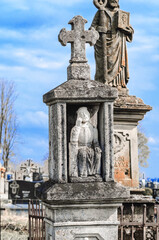 Fototapeta na wymiar Tombstones of saints in a small cemetery, Europe, Poland, Ukraine. Graves, cemetery