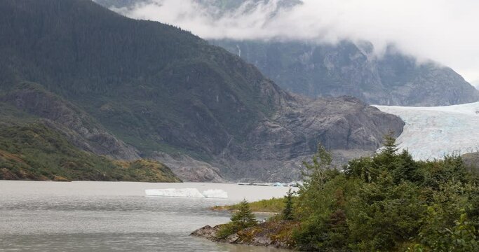 Mendenhall Glacier Nugget Falls Juneau Alaska pan. Waterfall glacial. Cruise ship destination near Juneau Alaska. Climate change global warming rapidly retreating glaciers.