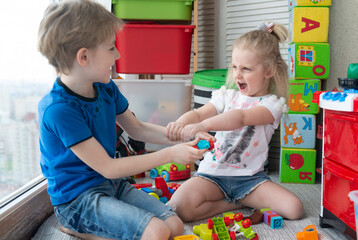  little boy and girl fighting over toy, siblings relationship, greed