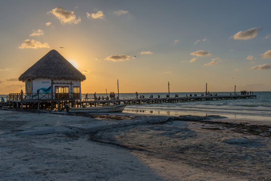 Unidentified people at sunset on the beach of Holbox Island, Mexico