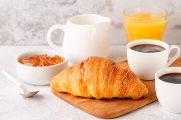 Hot coffee, croissants on a light background, selective focus.