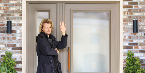 young man opening the door of his house.Inviting the guests