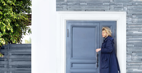 young man opening the door of his house.Inviting the guests