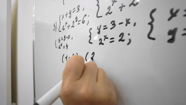  Woman maths lecturer is explaining material from whiteboard to students.