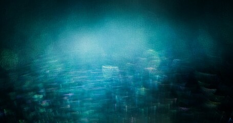 Bokeh glow overlay. Blur light flare. Shiny grain texture. Defocused blue green purple color flecks glare reflection on dark black abstract background.