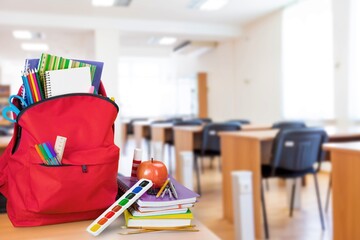 School classroom. New school bag on a student's desk in the classroom. Back to school concept