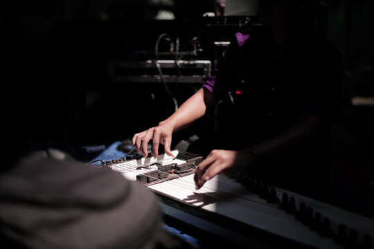 the player plays a typical Indonesian musical instrument called kecapi