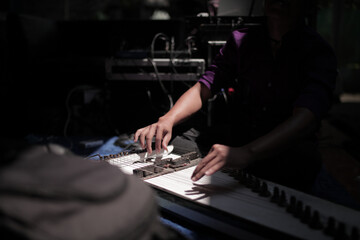 detail of the hand playing a musical instrument typical of Indonesia called kecapi