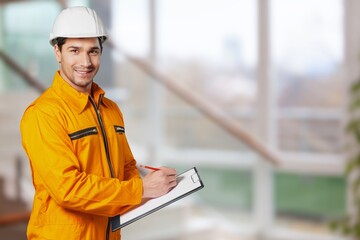 Portrait man worker supervisor with engineer safety suit work in large factory warehouse