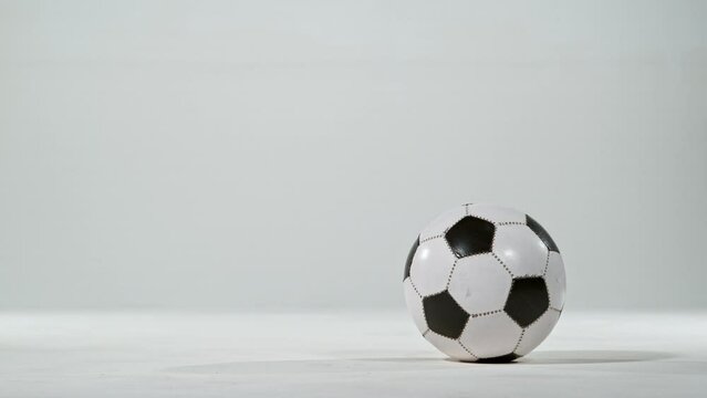 Super slow motion of jumping soccer ball on white background. Filmed on high speed cinema camera, 1000fps. 