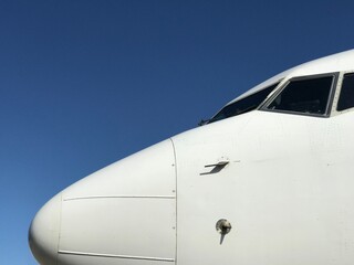 White Aeroplane Nose against clear Blue Sky 2