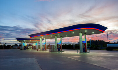 Fototapeta na wymiar Gas station with clouds and beautiful sky at sunset. Empty space.