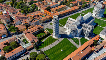 Panoramic aerial view of Leaning Tower of Pisa in Italy, Tuscany. Flying along Pisa Cathedral drone video of worldwide famous Italian tourist attraction in Europe in 6K