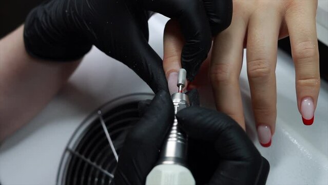 Slow mo hardware manicure in a beauty salon, the process of removing 