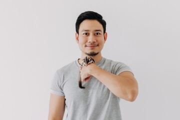 Cute little sugar glider pet hold on the asian man owner isolated on white.