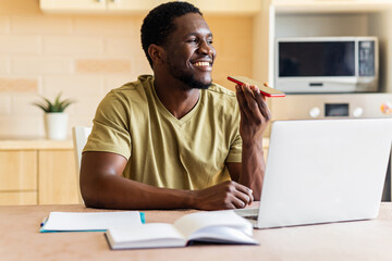 african american man in beige t-shirt record voice message by mobile cell phone at home