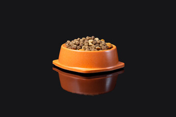 Food for cats and dogs on a mirror surface on a dark background.