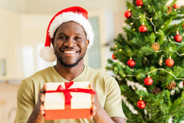 african american man feeling happy because he gives a christmas gift to family