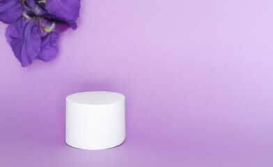 Purple iris flower with white display on purple background. Copy space.