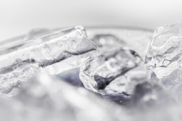 The heap of shiny ice cubes on a white background.