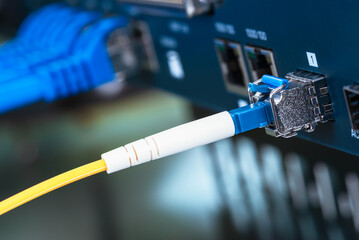 Internet switch in the data center with connected ethernet and fiber optical patch cord cables