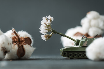 Model toy of battle tank firing cotton flowers from the barrel. Trendy Ukrainian banter about...