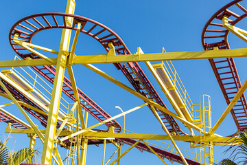 Roller coaster on blue sky background. Concept of an amusement park