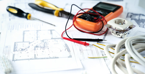 Making repairs,planning electricity project in house.Drawings,diagrams,plan for electrification of apartment, building. Devices and accessories, voltmeter, wires, screwdriver, pliers and tape measure