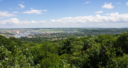 Fototapeta na wymiar Panoramic top view of the city of Pyatigorsk Stavropol territory in a green valley and a mountain on the horizon on a sunny summer day and a space to copy