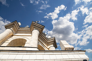Fragment of the Radisson Collection Hotel (historical name Hotel Ukraina, made in Stalinist Empire style) against the background of the sky with clouds, Moscow, Russia