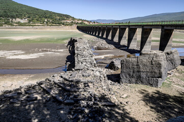 Close-up of the ruins of the Roman bridge of Vinuesa, Soria Spain. This bridge is most of the year sunk in the waters of the Cuerda del Pozo reservoir, Soria, Spain, discovered by the drought