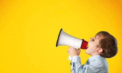 Portrait of young fun smart happy child hold megaphone loudspeaker back to school concept.