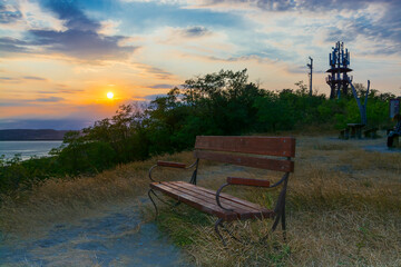 Fototapeta na wymiar Wooden bench and sunset panorama of Balaton
