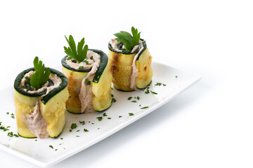 Grilled zucchini rolls stuffed with cream cheese and tuna isolated on white background