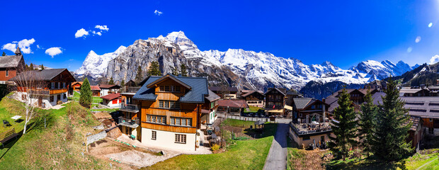 Switzerland nature and travel. Alpine scenery. Scenic traditional mountain village Murren surrounded by snow peaks of Alps. Popular tourist destination and ski resort - obrazy, fototapety, plakaty