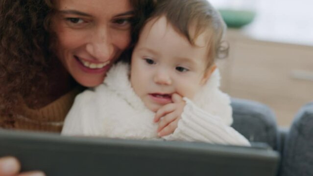 Happy Mother And Baby On A Video Call Via The Internet At Home Using A Tablet With Mom Waving Her Hand At Webcam. Kid, Child And Single Parent Having Fun And Greeting On Social Network Application