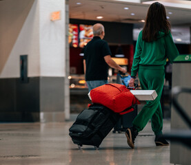 person with luggage at airport travel miami 