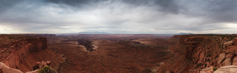 Fototapeta na wymiar Scenic Panoramic View of American Landscape and Red Rock Mountains in Desert Canyon. Cloudy Sky. Canyonlands National Park. Utah, United States. Nature Background Panorama