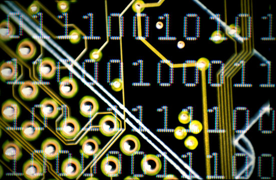 Binary code superimposed over a circuit board