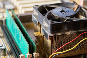 Old motherboard covered in dust and dirt. Close-up.