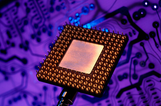 Close-up of a computer chip with a circuit board in the background