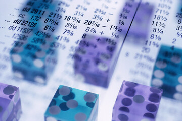 Financial report superimposed over dice