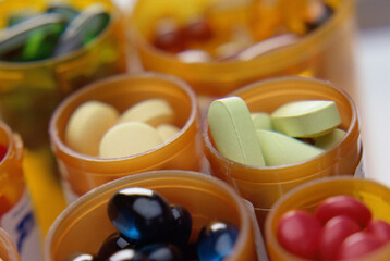 Close-up of an assortment of tablets and capsules in vials